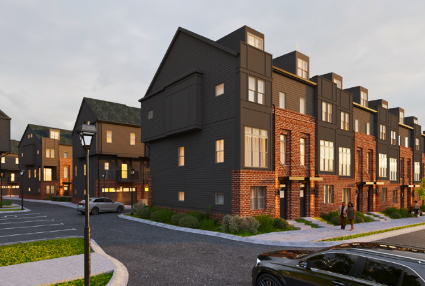Modern townhouses at Two West End feature brick, dark siding, landscaped streets, parked cars, and locals strolling under a glowing streetlamp.