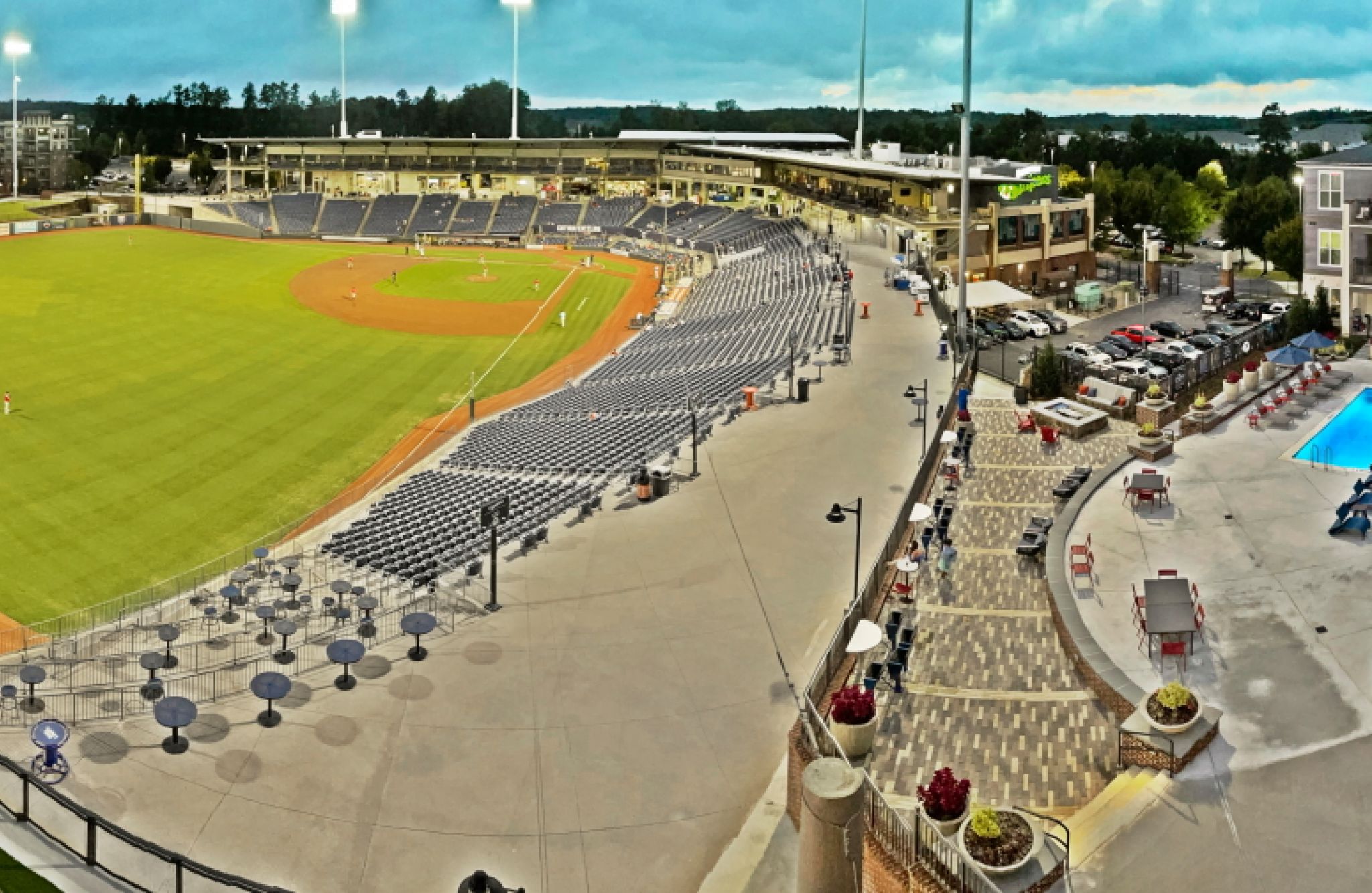 Stadium with baseball field and Fieldhouse Apartments' hotel pool area viewed from above.
