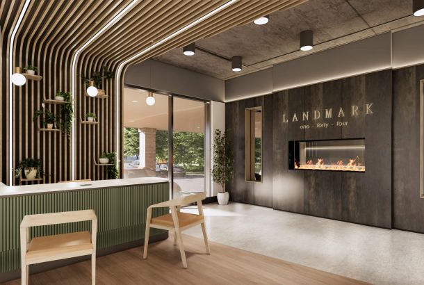 Modern lobby at Landmark at Dublin features wood accents, green plants, a fireplace, and a reception desk for welcoming Dublin apartments seekers.